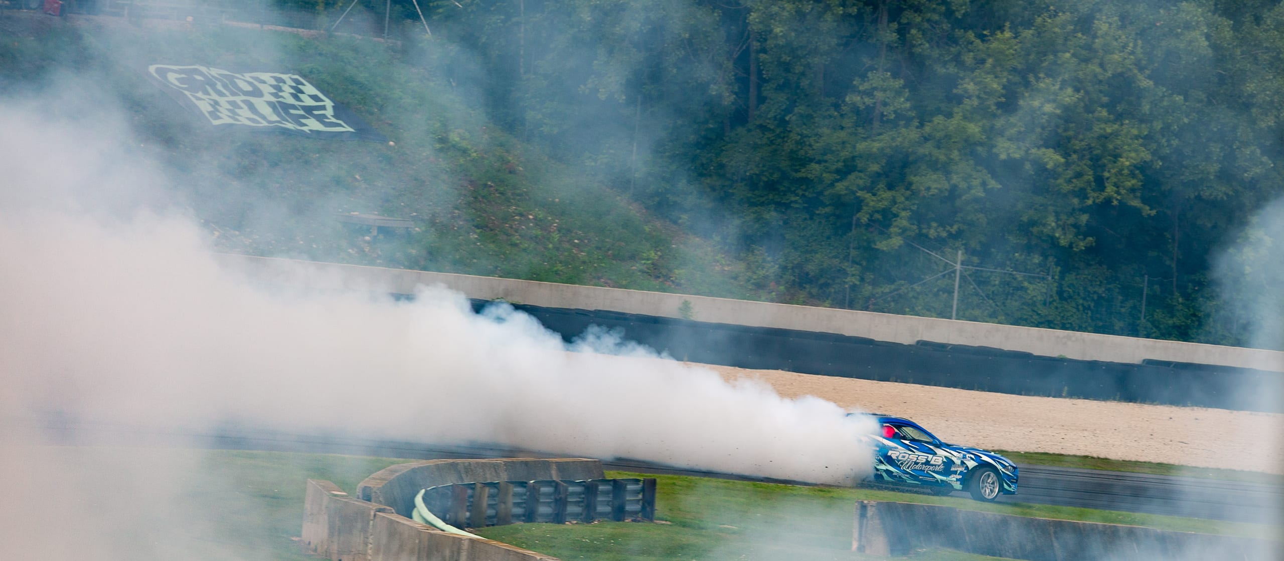GRIDLIFE drift car trailing smoke through a turn at Road America